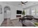 Open concept living room with plantation shutters, fireplace, television, hardwood floors and view into modern bathroom at 11732 Del Sur Ave, Las Vegas, NV 89138