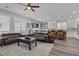 Spacious living room blends into kitchen with modern ceiling fan and ample seating, and a sliding door to the outside at 11732 Del Sur Ave, Las Vegas, NV 89138
