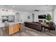Open concept living space with kitchen, eat-in area, living room with fireplace and television, plus hardwood floors at 11732 Del Sur Ave, Las Vegas, NV 89138