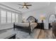 Spacious primary bedroom with a tray ceiling, ceiling fan, plantation shutters, and a decorative rug at 11732 Del Sur Ave, Las Vegas, NV 89138