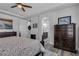 Inviting primary bedroom featuring a ceiling fan, wood-look flooring, and an ensuite bathroom at 11732 Del Sur Ave, Las Vegas, NV 89138