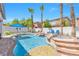 Inviting backyard with a pool, spa, stone accents, covered patio, and manicured landscaping at 11732 Del Sur Ave, Las Vegas, NV 89138