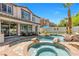The back of the house reveals a gorgeous pool, with a spa and plenty of seating at 11732 Del Sur Ave, Las Vegas, NV 89138