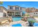 Beautiful backyard showcasing a refreshing pool, rock waterfall, and patio seating area at 11732 Del Sur Ave, Las Vegas, NV 89138