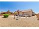 Desert landscaped backyard with covered patio, desert landscaping and neutral color palette at 1204 Golf Club, Laughlin, NV 89029