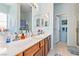 Bright bathroom featuring a double vanity, decorative mirrors, and a separate shower area at 1204 Golf Club, Laughlin, NV 89029