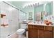 Bathroom with a shower, toilet, and vanity, highlighted by wood finishes and practical storage at 1204 Golf Club, Laughlin, NV 89029