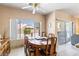 Dining room showcases a wood table, chairs, a large window looking to backyard, and sliding glass door at 1204 Golf Club, Laughlin, NV 89029