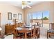 Bright dining area with a wooden table set, large window offering backyard view and plenty of natural light at 1204 Golf Club, Laughlin, NV 89029