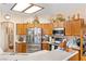 Spacious kitchen boasts wooden cabinets, stainless appliances, and ample countertop space with a light fixture overhead at 1204 Golf Club, Laughlin, NV 89029