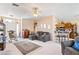 Comfortable living room featuring neutral tones, ceiling fan, and an inviting gray sofa with decorative pillows at 1204 Golf Club, Laughlin, NV 89029