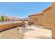 Cozy patio area with stucco wall, desert landscaping, and outdoor seating at 1204 Golf Club, Laughlin, NV 89029