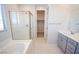 Bathroom featuring a soaking tub, glass shower, and modern vanity at 12101 Arrebol Ave, Las Vegas, NV 89138