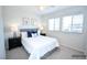 This staged bedroom features bright windows, neutral walls and soft carpet at 12101 Arrebol Ave, Las Vegas, NV 89138