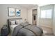 Staged bedroom with queen-sized bed, neutral decor, and closet provides a cozy retreat at 12101 Arrebol Ave, Las Vegas, NV 89138