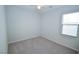 A well-lit, carpeted bedroom with a ceiling fan and a window at 12101 Arrebol Ave, Las Vegas, NV 89138