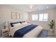 Staged bedroom featuring soft carpet, two windows, and white decor at 12101 Arrebol Ave, Las Vegas, NV 89138
