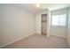 This neutral bedroom offers a ceiling fan, closet, and a window for natural light at 12101 Arrebol Ave, Las Vegas, NV 89138