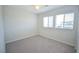 Neutral bedroom with two windows and neutral carpet offers natural light at 12101 Arrebol Ave, Las Vegas, NV 89138
