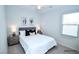 A staged bedroom featuring two windows, neutral walls and soft carpet at 12101 Arrebol Ave, Las Vegas, NV 89138