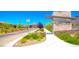 Attractive community entrance with desert landscaping, mountains in the distance, and decorative signage at 12101 Arrebol Ave, Las Vegas, NV 89138