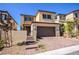 Inviting two-story home featuring a two-car garage and stylish stone accents at 12101 Arrebol Ave, Las Vegas, NV 89138