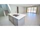 Modern kitchen overlooking living area, featuring a large island with a sink at 12101 Arrebol Ave, Las Vegas, NV 89138
