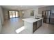 Open-concept kitchen with a large island, stainless steel appliances, and tile flooring at 12101 Arrebol Ave, Las Vegas, NV 89138