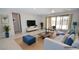 Staged living room with stylish furniture, tile floors, and sliding glass doors at 12101 Arrebol Ave, Las Vegas, NV 89138