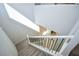 A staircase with iron railing, carpeted stairs, and natural light from above at 12101 Arrebol Ave, Las Vegas, NV 89138