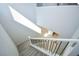 Bright, carpeted staircase with modern metal railing overlooks a light-filled entryway at 12101 Arrebol Ave, Las Vegas, NV 89138