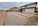Large backyard featuring neutral-toned walls, gravel, and a partially covered patio with space for outdoor activities at 1288 Ventura Cliffs Ave, Henderson, NV 89012