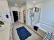 Bright bathroom showcasing tub-shower, double vanity sinks and a spacious layout with tile flooring at 1288 Ventura Cliffs Ave, Henderson, NV 89012