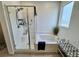 Bathroom with tiled tub-shower featuring glass door and a bench sitting next to the tub at 1288 Ventura Cliffs Ave, Henderson, NV 89012