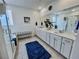 Bright bathroom with double vanity sinks, tub-shower and neutral walls, complemented by tile flooring at 1288 Ventura Cliffs Ave, Henderson, NV 89012