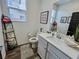 Neat bathroom with white vanity, decorative accents, and modern fixtures at 1288 Ventura Cliffs Ave, Henderson, NV 89012