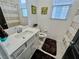 Bright bathroom features a vanity with sink and tiled floors at 1288 Ventura Cliffs Ave, Henderson, NV 89012