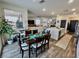Spacious dining area with a wooden table set for six, flowing into an open-concept living space at 1288 Ventura Cliffs Ave, Henderson, NV 89012