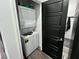Efficient laundry closet featuring a stacked washer and dryer unit, maximizing space in the home at 1288 Ventura Cliffs Ave, Henderson, NV 89012