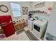 Cozy laundry room features washer, dryer, decor, and a small red fridge at 1288 Ventura Cliffs Ave, Henderson, NV 89012