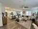 Open floor plan showcasing kitchen, dining, and living room with modern furnishings and natural light at 1288 Ventura Cliffs Ave, Henderson, NV 89012
