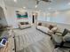 Spacious living room features plush couches, neutral decor, and a ceiling fan at 1288 Ventura Cliffs Ave, Henderson, NV 89012