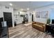 Modern living area showcasing laminate flooring, contemporary furniture, and a bright, open atmosphere at 1288 Ventura Cliffs Ave, Henderson, NV 89012