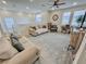 Bright living room with neutral colored couches, a ceiling fan, and large windows at 1288 Ventura Cliffs Ave, Henderson, NV 89012