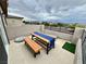 Outdoor patio featuring a wooden table and bench, perfect for enjoying outdoor meals and views of the surrounding neighborhood at 1288 Ventura Cliffs Ave, Henderson, NV 89012