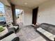 Charming front porch with stone accents, outdoor seating, and a view of the paved driveway and home's entrance at 1288 Ventura Cliffs Ave, Henderson, NV 89012