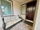 Covered front porch with a comfortable sofa, providing a relaxing outdoor space near the home's entrance at 1288 Ventura Cliffs Ave, Henderson, NV 89012