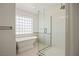 Modern bathroom featuring a sleek glass shower and separate soaking tub in a naturally lit area at 1470 St Joseph St, Overton, NV 89040