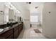 Bright bathroom featuring dual vanity, granite counters, soaking tub and separate glass shower at 1470 St Joseph St, Overton, NV 89040