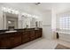 Well-lit bathroom featuring a double vanity, bath tub and granite countertops at 1470 St Joseph St, Overton, NV 89040